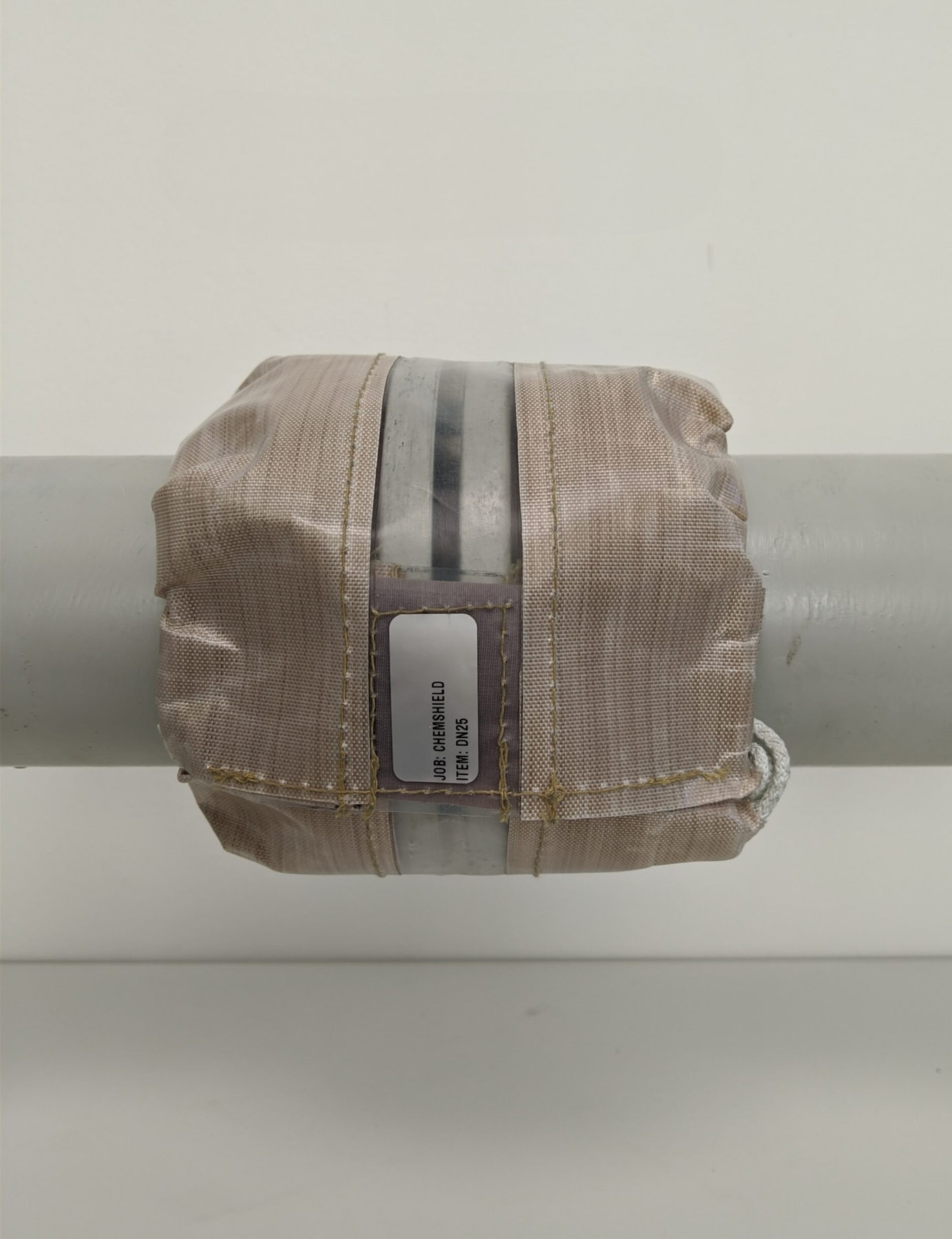 Flange spray shield installed on a pipe connection